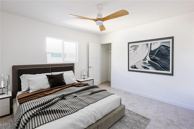 bedroom featuring a closet, baseboards, light colored carpet, and a ceiling fan