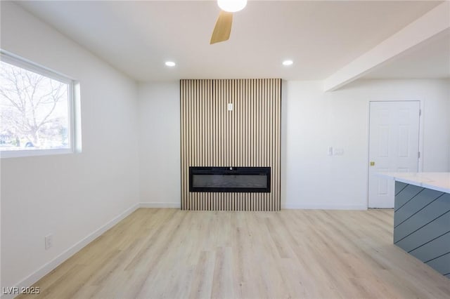 unfurnished living room featuring a ceiling fan, recessed lighting, light wood-style floors, and baseboards