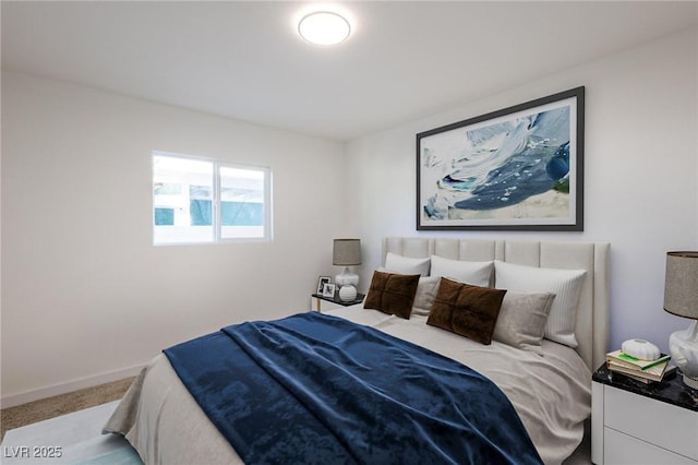 bedroom with baseboards and carpet