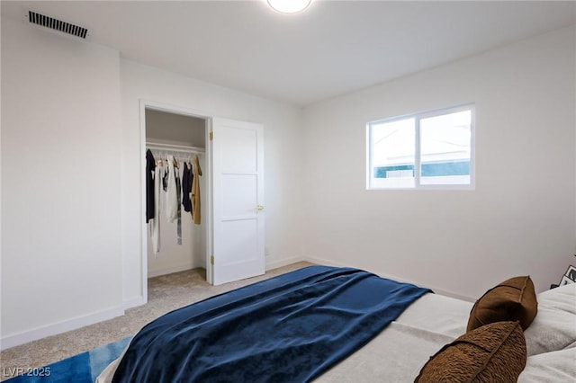 bedroom featuring light carpet, visible vents, and baseboards