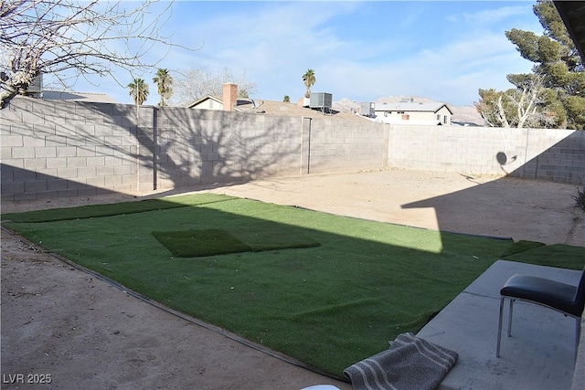 view of yard featuring a fenced backyard and cooling unit