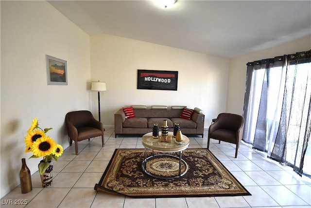 living room with light tile patterned floors and vaulted ceiling