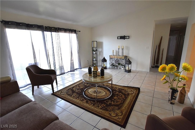 living area with light tile patterned floors and vaulted ceiling