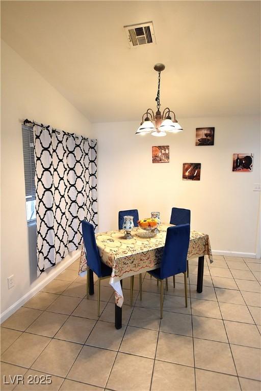 dining area featuring a chandelier, light tile patterned floors, visible vents, and baseboards