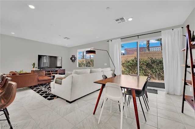 living area featuring recessed lighting, visible vents, and light tile patterned floors