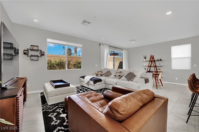 living room with recessed lighting, visible vents, and baseboards