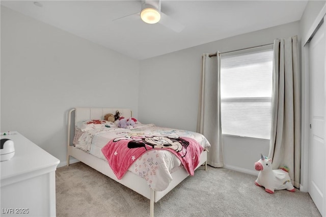 bedroom with ceiling fan, baseboards, and light carpet