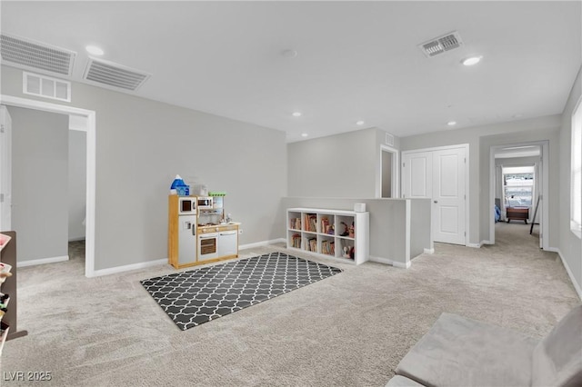 interior space with carpet flooring, recessed lighting, and visible vents