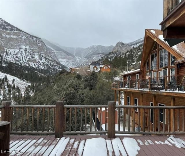 snow covered deck featuring a mountain view