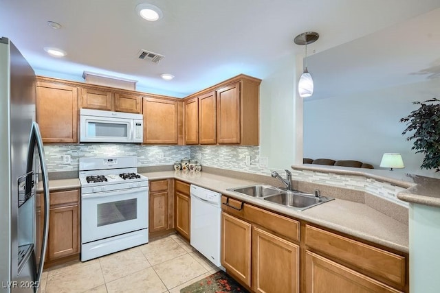 kitchen with white appliances, backsplash, a sink, and visible vents