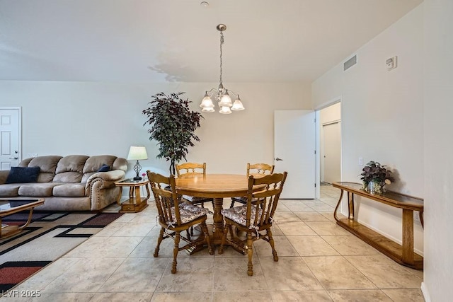 dining area featuring light tile patterned floors, visible vents, and a notable chandelier