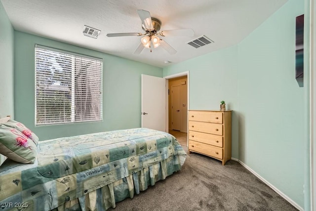 bedroom featuring a ceiling fan, carpet flooring, visible vents, and baseboards