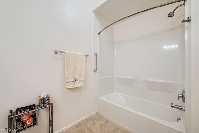 bathroom with baseboards and shower / bathing tub combination