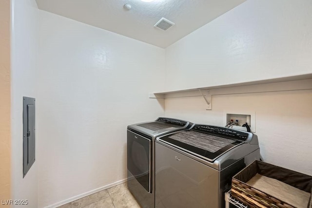 washroom featuring laundry area, light tile patterned floors, electric panel, visible vents, and washer and clothes dryer