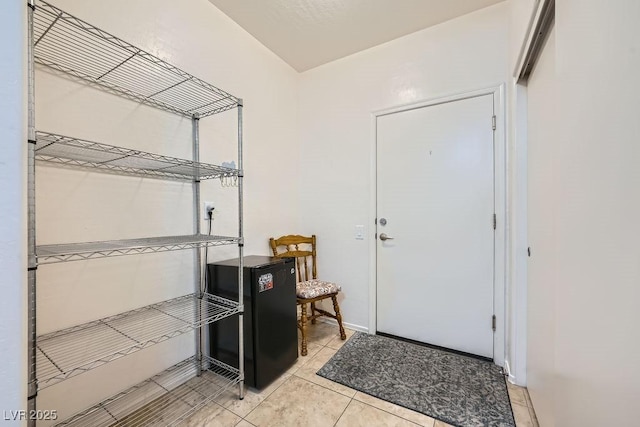 foyer entrance featuring light tile patterned floors