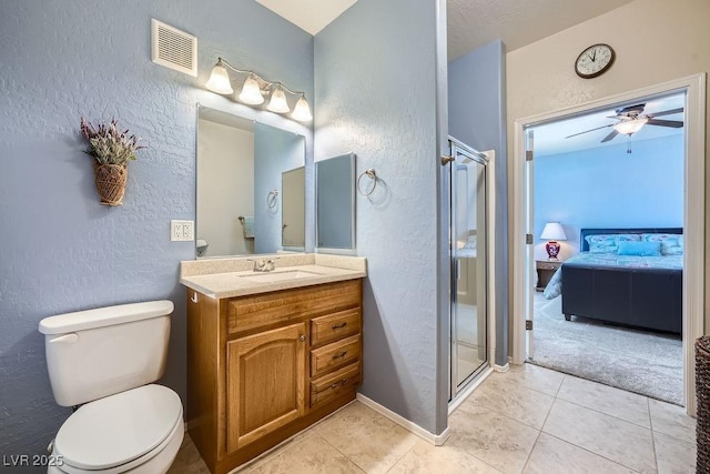 ensuite bathroom featuring visible vents, toilet, a shower stall, ensuite bath, and vanity