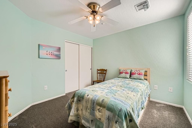 carpeted bedroom featuring a ceiling fan, baseboards, visible vents, and a closet