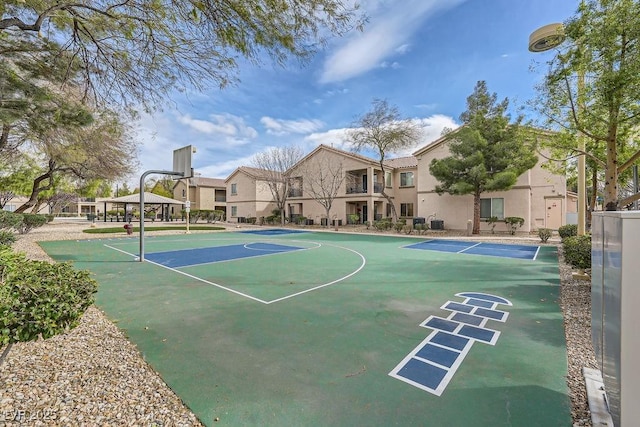 view of sport court featuring a residential view and community basketball court