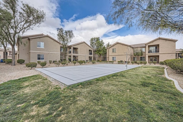 view of sport court with a residential view and a lawn