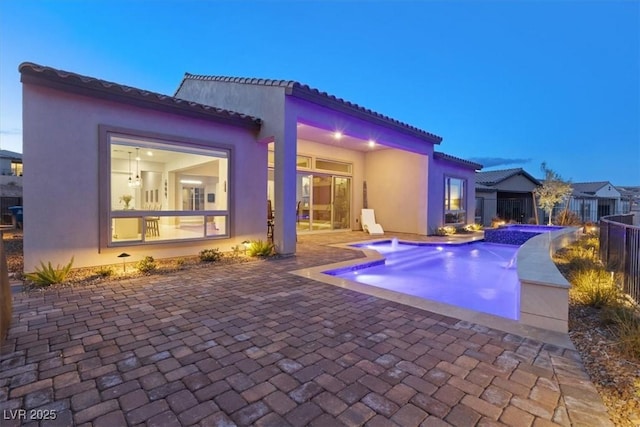 view of pool with a patio area and a pool with connected hot tub