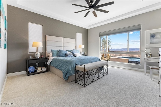 carpeted bedroom with a ceiling fan and baseboards