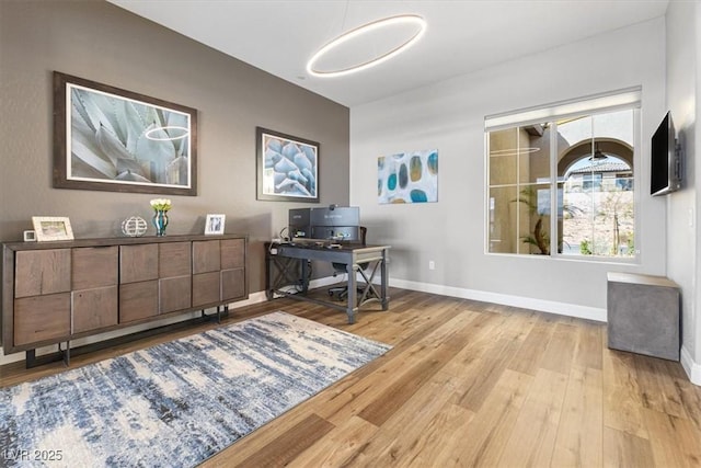 home office featuring baseboards and wood finished floors