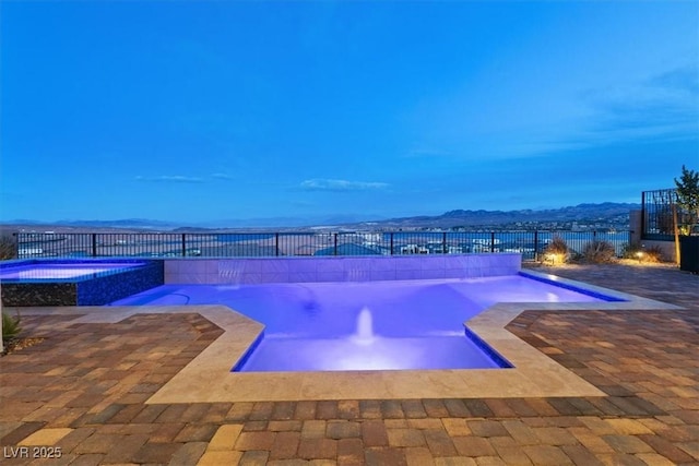 view of pool with a patio area, a fenced backyard, and a pool with connected hot tub