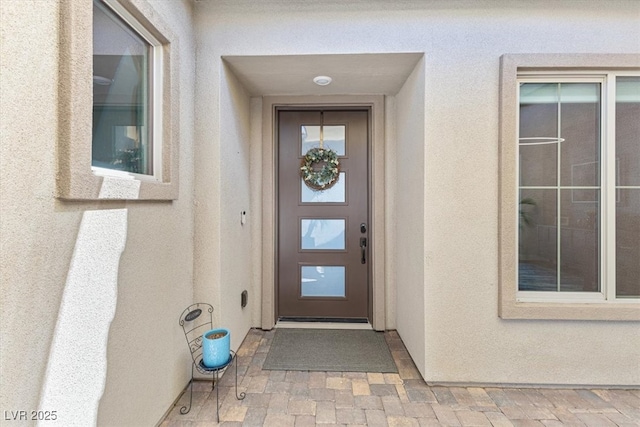 property entrance featuring stucco siding