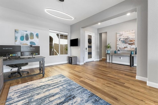 home office featuring wood finished floors and baseboards