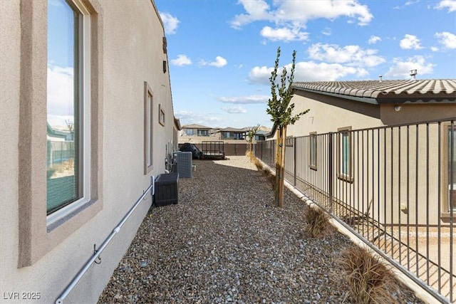 view of yard featuring cooling unit and fence