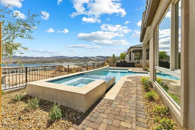 view of pool with a fenced backyard, a patio, a fenced in pool, and an in ground hot tub