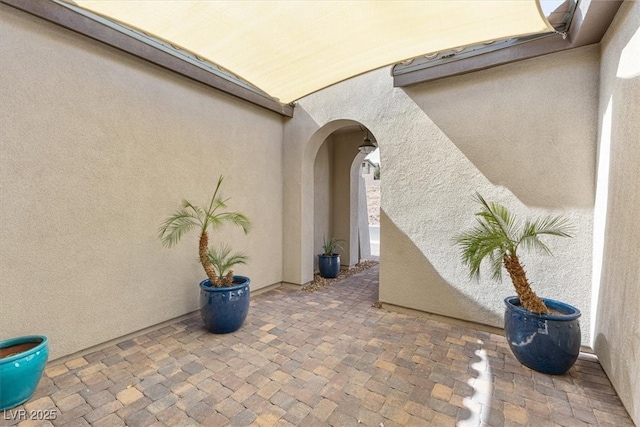 doorway to property with a patio area and stucco siding