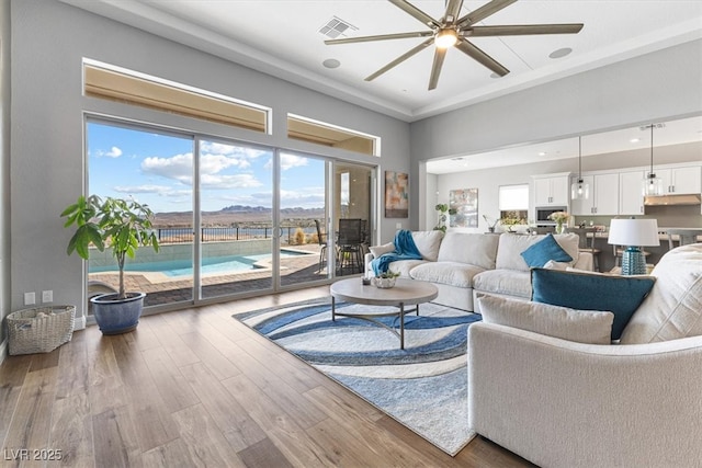 living room with recessed lighting, wood finished floors, visible vents, and a ceiling fan