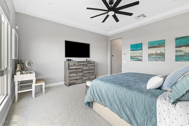 carpeted bedroom with a ceiling fan, visible vents, and baseboards