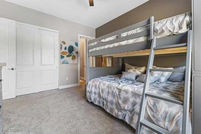 bedroom with carpet floors, baseboards, a ceiling fan, and a closet