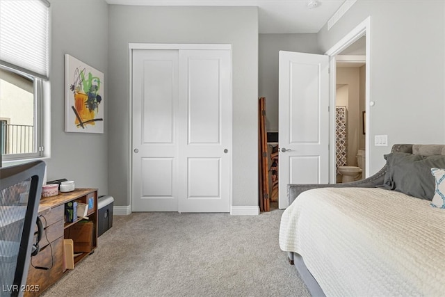 bedroom with carpet, a closet, and baseboards