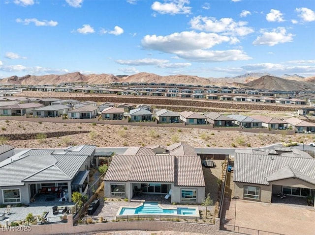 drone / aerial view featuring a residential view and a mountain view