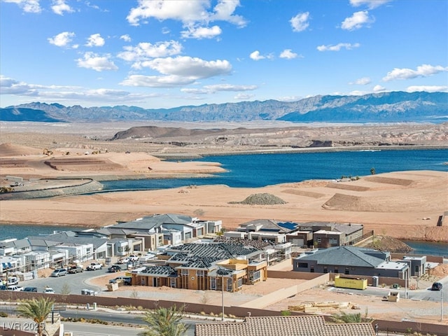 drone / aerial view featuring a water and mountain view and a residential view