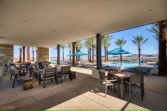 view of patio / terrace with outdoor dining area and a community pool