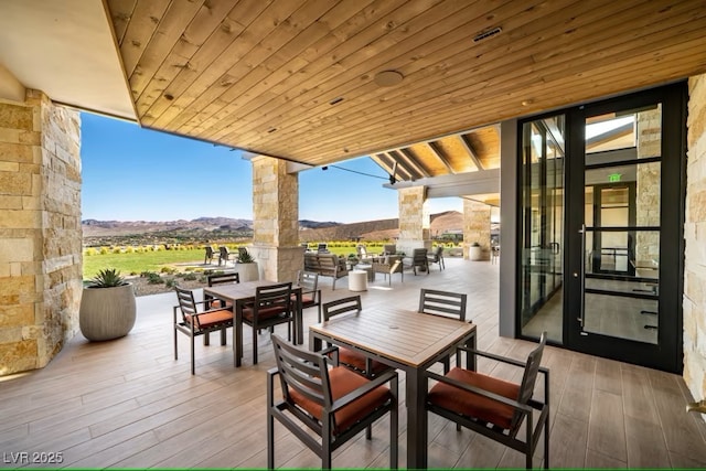 view of patio with a mountain view and outdoor dining area