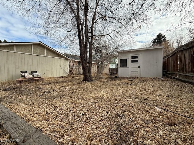 view of yard featuring a fenced backyard and an outdoor structure