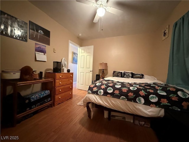 bedroom with a ceiling fan and wood finished floors