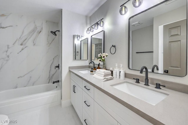 bathroom with washtub / shower combination, visible vents, a sink, and double vanity