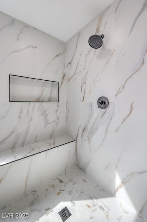 full bath featuring a marble finish shower