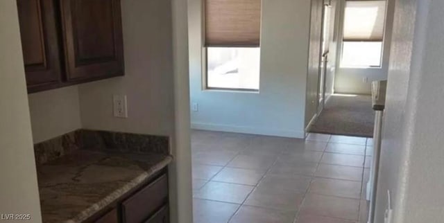 bathroom with vanity, baseboards, and tile patterned floors