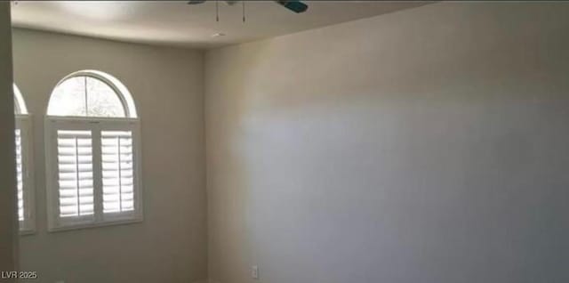 spare room featuring a wealth of natural light and ceiling fan