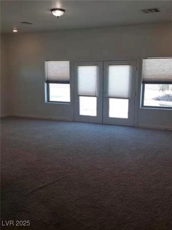 carpeted empty room with visible vents