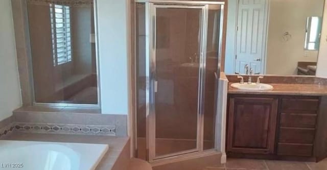 bathroom featuring vanity, a stall shower, tile patterned flooring, and a bath