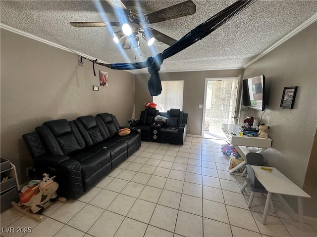 living room featuring a textured ceiling, ornamental molding, light tile patterned flooring, and a ceiling fan