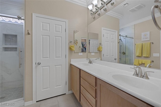 full bathroom featuring visible vents, a shower stall, crown molding, and a sink